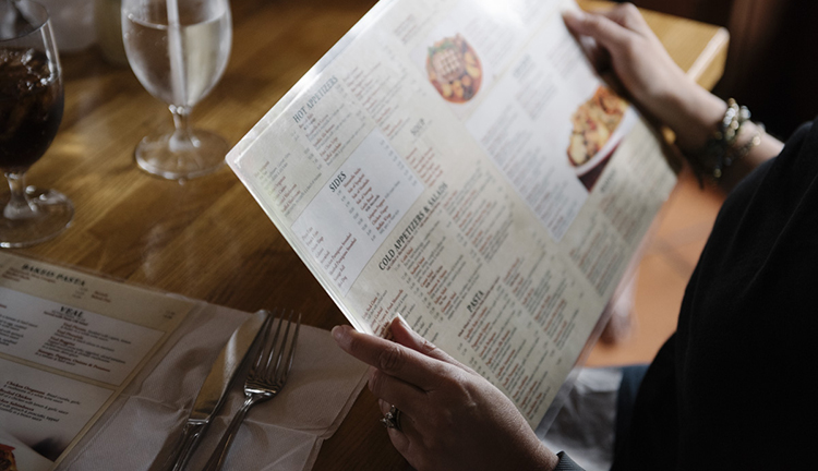 Woman looking at menu in restaurant