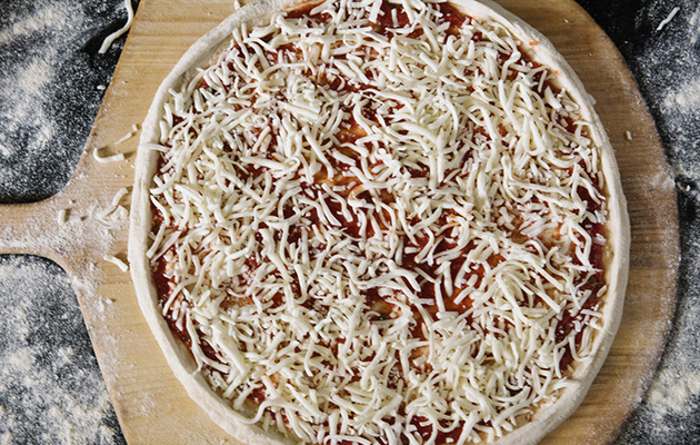 Pizza covered in Grande Shredded Mozzarella